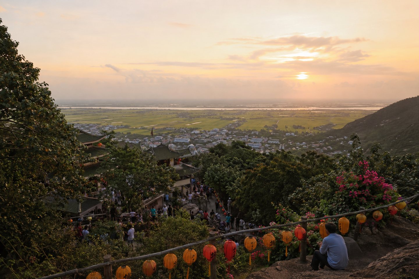An Giang viewed from a hillside pilgrimage site at sunset, looking across the Delta plain