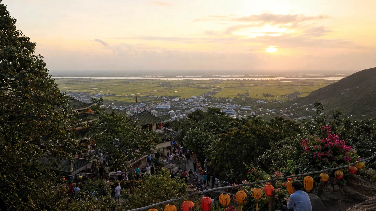 An Giang viewed from a hillside pilgrimage site at sunset, looking across the Delta plain