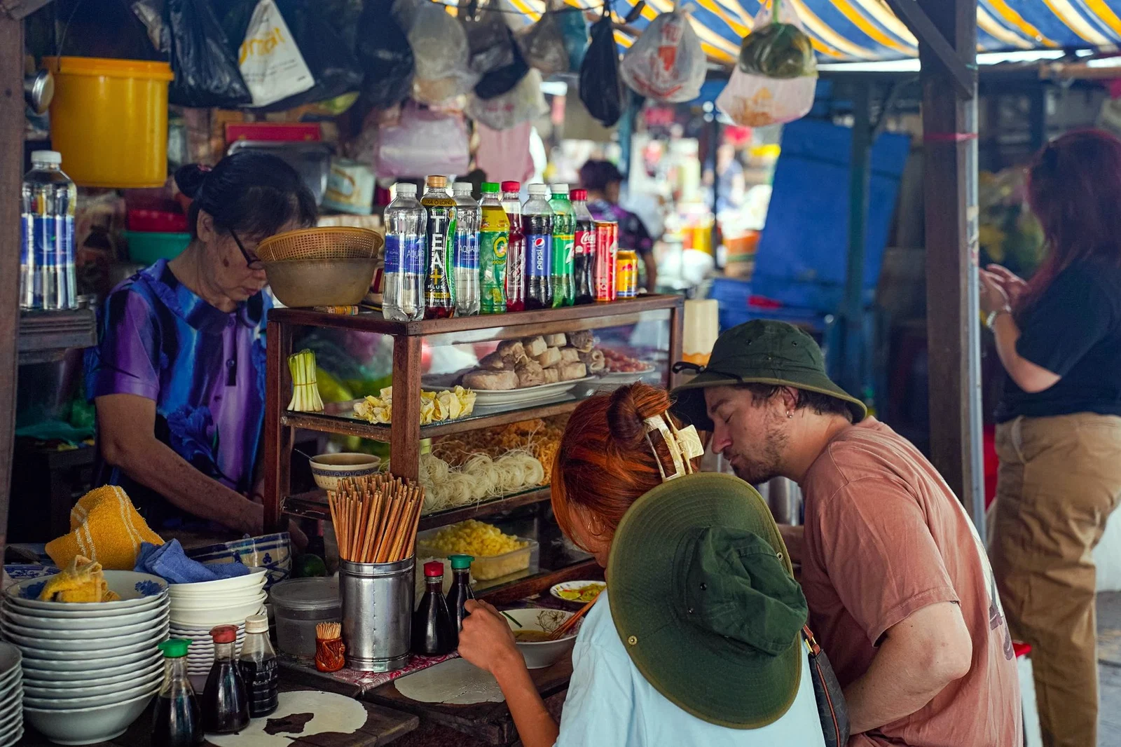Travellers at a street food stall in Saigon