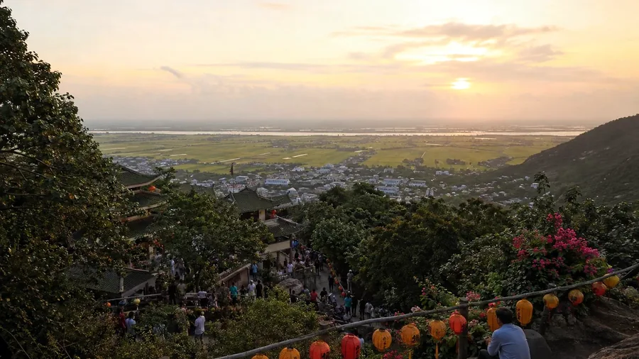 An Giang viewed from a hillside pilgrimage site at sunset, looking across the Delta plain
